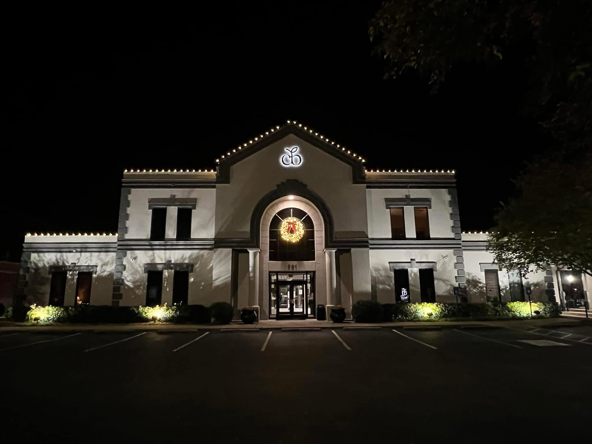 Stone home Christmas roofline lighting
